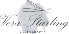 A logo for "Vera Starling Videography" with a watercolor-style background. "Vera Starling" is written in elegant dark gray cursive across the center. Above the name, a stylized, thin line forms an abstract wing-like or flourish design. Below the name, "VIDEOGRAPHY" is written in a simple, dark gray sans-serif font. The background is a soft, light gray watercolor smudge on a dark green solid background.